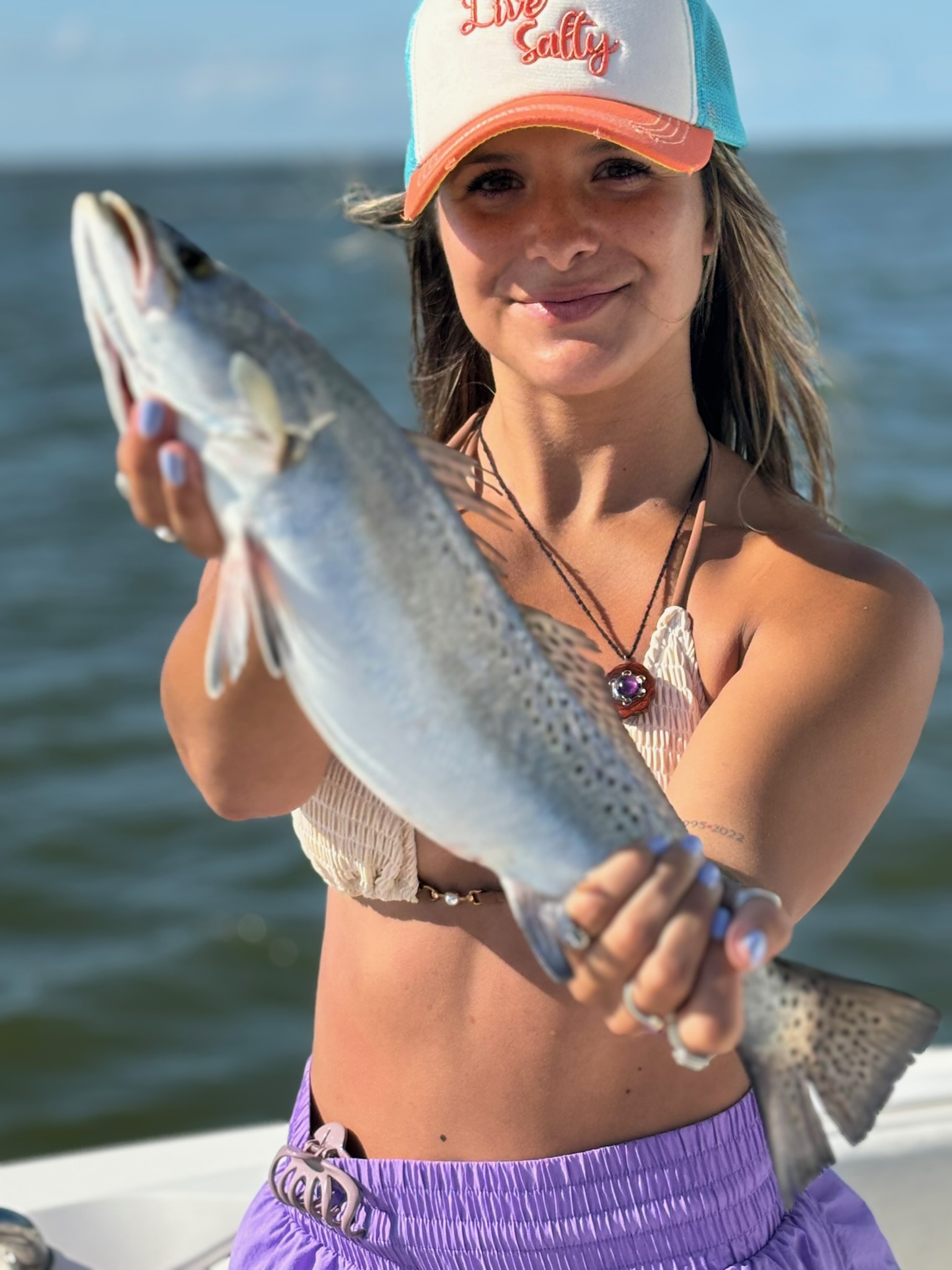 Woman with speckled trout on Galveston Bay charter